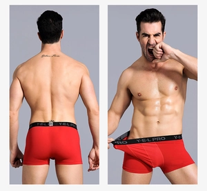 Detail view of red men's athletic boxer briefs with high-elastic wide logo waistband
