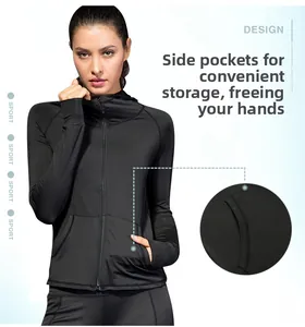Detail view of women's black hooded fitness jacket with zippered side pockets and slim fit