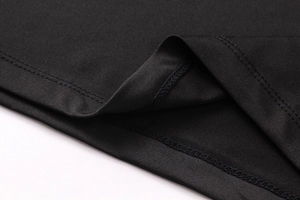 Close-up of black sports fabric showing professional double-needle stitching and texture