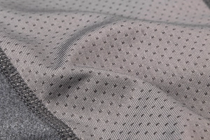 Détail du tissu en maille grise respirante avec coutures renforcées pour short de sport homme
