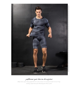 Detail showing charcoal grey 3D hexagonal compression texture on men's quick-dry gym gear