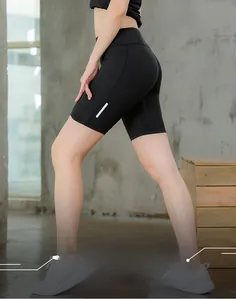 Detail of high waist fitness shorts with reflective strips and breathable black fabric