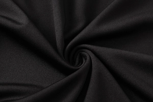 Close-up detail of high-elastic black knitted fabric with breathable mesh texture