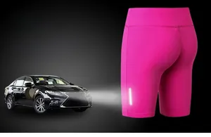 Detail of rose red compression shorts featuring a high-visibility reflective safety strip