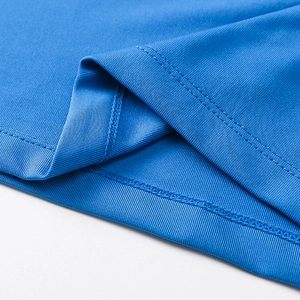 Detailed view of the double-needle stitched hem on blue professional athletic shirt