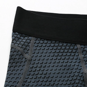 Close-up of professional four-needle six-thread stitching on 3D geometric sports shorts