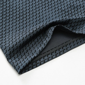 Detail of grey-blue men's athletic shorts featuring geometric print and double stitching