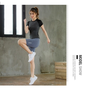 Dynamic model shot of slim fit quick-dry yoga shorts and raglan sleeve top set