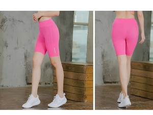 Detail showing high-waist rose red yoga shorts with silver reflective side stripes