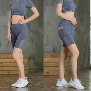 Detail view of high-waist yoga shorts featuring a side phone pocket and breathable mesh panels