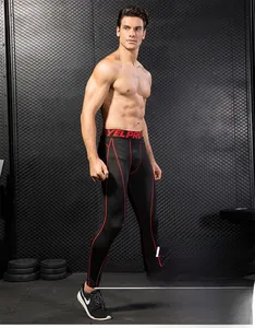 Close-up of men's athletic leggings with red stitching in a gym setting