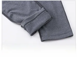Detail view of smooth hem and reinforced stitching on men's compression pants