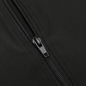 Detailed macro view of the matte black metal zipper and smooth knit fabric on the hoodie