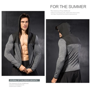 Detail of slim-fit men's athletic hoodie showing two-tone grey and black paneling