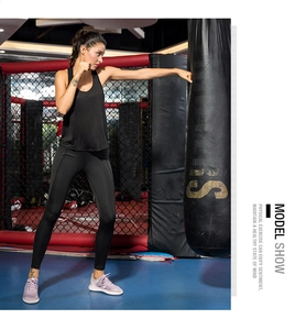 Action shot of women's black yoga set on a boxing ring showing flexible support and fit
