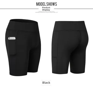Detail view of high-waisted black yoga shorts with convenient side phone pocket and stretch fabric