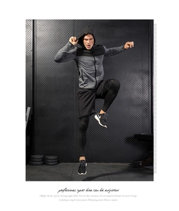 Dynamic view of men's athletic hoodie and quick-dry compression set for training