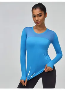 Detail of mesh panels and thumbhole cuffs on blue high-stretch athletic long sleeve top