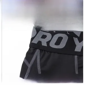 Detail of wide elastic waistband with PRO lettering on men's athletic compression pants