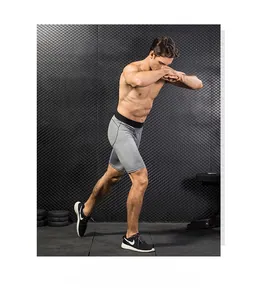 Dettaglio dei pantaloncini a compressione grigi da uomo in tessuto elasticizzato e vita