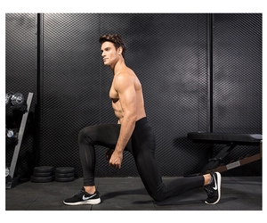 Detail of black compression pants showing stretch and muscle fit in gym