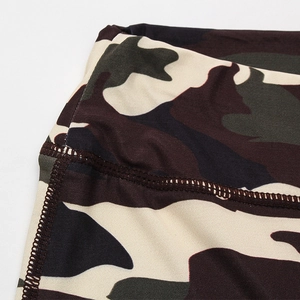 Detail of camouflage yoga shorts featuring high-elastic knit fabric and flatlock stitching