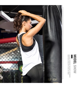Detail of white loose sports vest with ENERGY lettering and black high waist yoga leggings