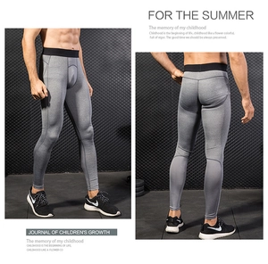 Close-up of men's grey pro compression pants with breathable mesh and elastic waistband