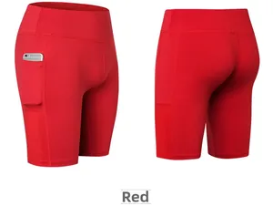 Detail view of red high-waist yoga shorts showing side pocket and breathable mesh panels