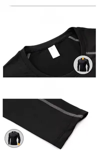 Detailed close-up of crew neck and durable flatlock stitching on black compression shirt