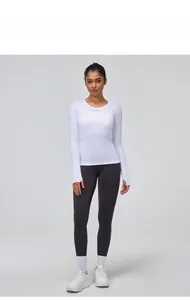 Close-up of athletic white long sleeve shirt showing cuff thumbhole detail and fit