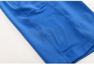 Detail of bright blue yoga shorts featuring breathable side mesh pocket and flatlock seams
