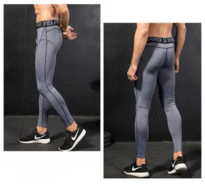 Detail view of men's grey compression pants showing elastic waist with pro lettering