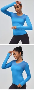 Detail of blue long-sleeve gym top showing breathable mesh stitching and thumbhole cuffs