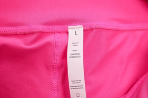 Macro view of yoga shorts fabric label showing 85% polyester and 15% spandex composition