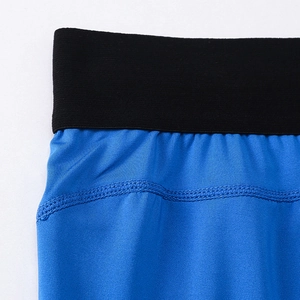 Close-up of royal blue compression pants showing elastic waistband and ribbed texture