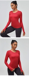 Detail of red long sleeve sports top with thumbhole cuffs and quick-dry mesh paneling