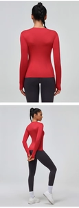 Detail of breathable red long sleeve sports shirt featuring mesh fabric and thumbhole cuffs