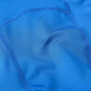 Close-up of blue breathable mesh fabric and professional flatlock stitching for sports pants