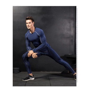 Detail of navy compression shirt and pants showing reinforced gray stitching and stretch