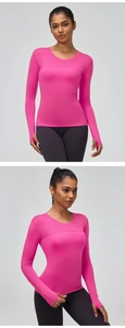Detail of pink sports top featuring ergonomic seams and functional thumbholes for fitness