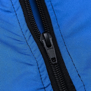 Macro view of matte black zipper and vertical ribbed texture on men's blue sports hoodie
