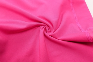 Close-up of rose red yoga shorts featuring elastic fabric and durable flatlock stitching