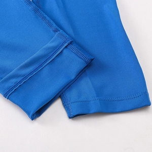 Macro view of blue athletic leggings featuring reinforced stitching and breathable fabric