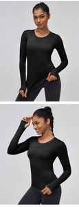Detailed view of black athletic long sleeve shirt with functional thumbholes for fitness