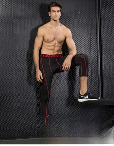 Detail of men's compression tights with red stitching on moisture-wicking fabric