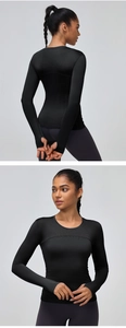 Detail of black sports top featuring thumbhole cuffs and breathable elastic fabric