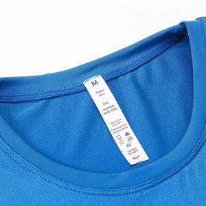 Macro detail of breathable mesh fabric and size label on blue women's athletic shirt