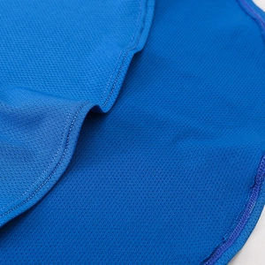 Close-up of breathable blue mesh fabric and double stitching on women's yoga vest