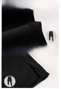 Detail of four-needle six-thread stitching and side split hem on black men sports pants